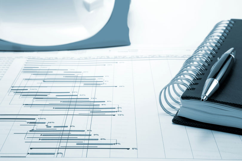 Planner sitting on top of financial chart